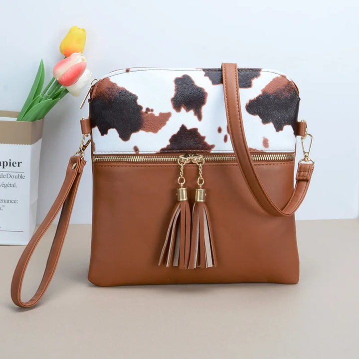 Tiffany - crossbody tas met kwastjes en koeienprint